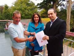 Householders being presented with their 20 year Polyroof 185 guarantee.